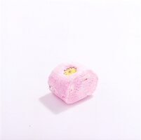 Piece of pink shower soap with yellow flower in it on white background
