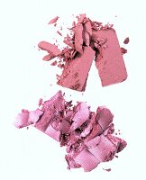 Close-up of red and pink loose powder on white background