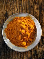 A plate of turmeric powder (seen from above)