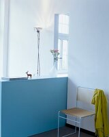 Room with chair, flower pot and blue sideboard