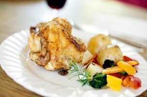 Chicken with vegetables served on plate