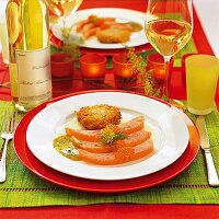 Marinated salmon with mustard sauce, dill, potato pancakes and caviar on plate