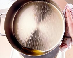 Cooking oil spread in steel casserole