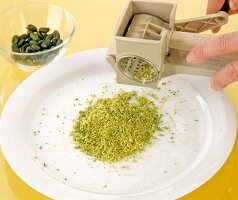 Crushed pistachio on plate using crusher
