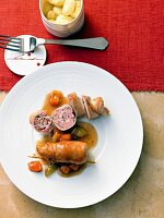 Turkey roulade stuffed with meat on plate