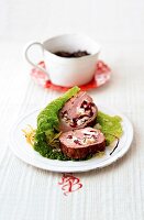 Pork tenderloin with cranberry and herb filling on plate