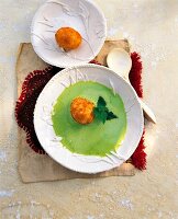 Nettle soup with egg on plate