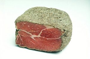 Ardennes ham with ground pepper crust on white background