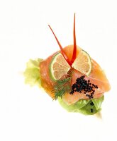 Brotschnittchen with lettuce, salmon, caviar, dill and lime in butterfly form