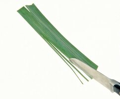 Leaf of leek cut in thin strips with knife