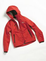 Close-up of red hooded anorak on white background
