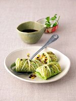 Savoy cabbage rolls with lentil and olive filling on plate