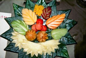 Various carved fruit served on leaf in Thailand