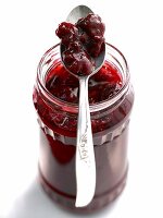 Glass jar of black forest kisch jam with spoon on it