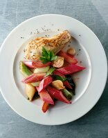 Chicken breast fillet with rhubarb and onions on plate