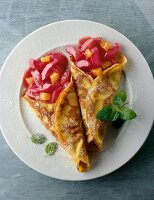 Pancakes with rhubarb and apricot compote on plate