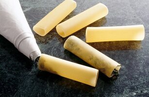 Cannelloni being filled with piping bag