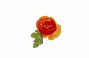 Tomato rose with parsley on white background