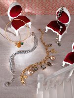 Close-up of bracelets and bangles arranged on doll house chair