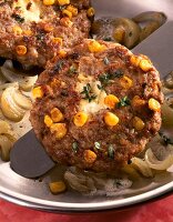 Close-up of meatballs with corn and feta cheese fried till golden brown