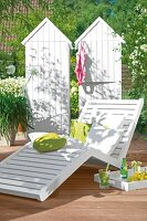 White deck chair in garden deck with cushions