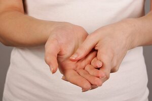 Close-up of woman applying lotion on her palms