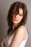 Pensive Magdalena woman with wet brown hair, looking down