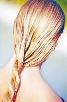 Rear View of blonde woman's pigtail with hair care products