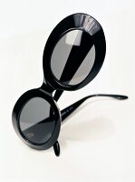 Close-up of black oval shaped sunglasses on white background