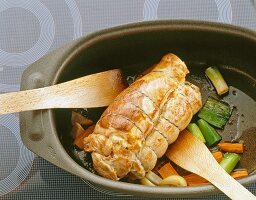 Roast meat with vegetables in pan