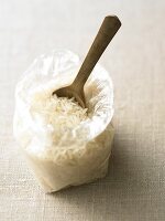 Wooden spoon in plastic bag filled with jasmine rice