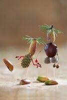 Tinkered little men crafted from larch fruit, acorns and larch needles