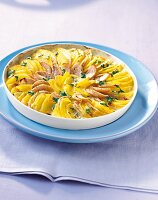 Potato gratin with gorgonzola and pears in bowl