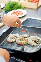 Close-up of prawns and chilli being fried in pan