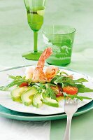 Close-up of chilli prawns with salad, avocado and arugula on plate