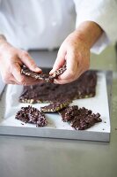 Close-up of chef breaking chocolate into pieces