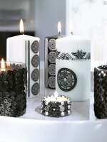 Close-up of candles decorated with sequins and beads in black and white