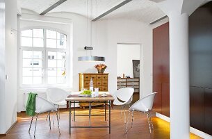 Dining room in white with high ceiling and transom windows