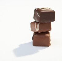 Stack of chocolates on white background
