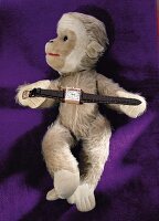 Stuff toy with 40's style watch in brown on purple background