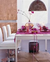 Festively decorated white dining table in pink with sparkles