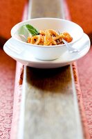 Veal tripe and basil with tomato sauce in bowl