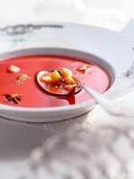 Close-up of tomato soup with crispy croutons on plate