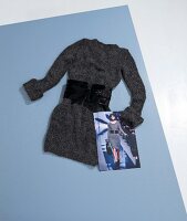 Gray mohair dress and wide belt with photograph on gray surface
