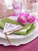White crockery set on pink and green napkin