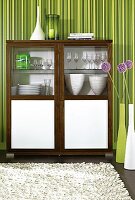 Wooden cabinet with glass doors, glasses and stack of plates