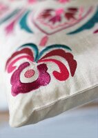 Close-up of embroidered silk pillow with floral pattern
