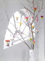 Branches decorated with colourful hanging paper flowers