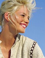 Side profile of a laughing blonde woman