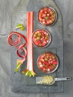Rhubarb and gooseberry jam in bowls with chopped ginger in flour scoop